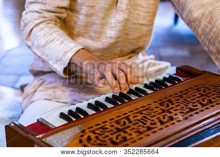 Closeup Of Shamanic Male Hands On Harmonium Keys Playing Sacred Kirtan Music For Divine Power And Sp