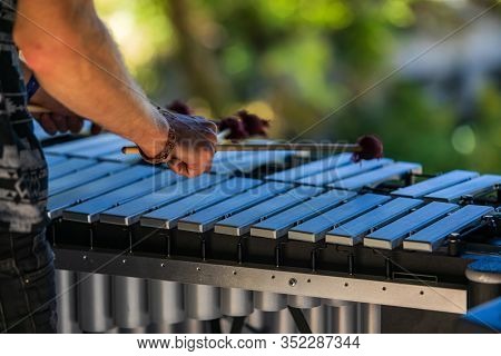 A Close Up And Rear View Of A Folk Musician Playing A Vibraphone On Stage At A Multicultural Festiva