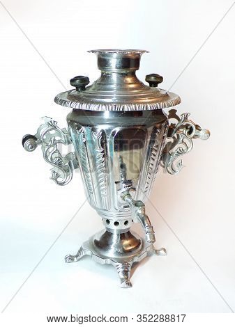 A Traditional Russian Samovar Made Of Silver Is Isolated On A White Background. A Beautiful And Anci