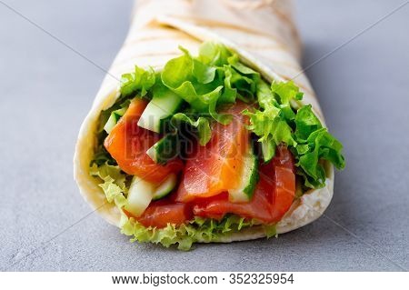 Wrap Sandwich, Roll With Fish Salmon And Vegetables. Grey Background. Close Up.