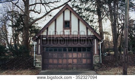 A Rustic Old White And Brown Garage With 1 Window
