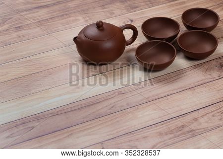 Yixing Clay Teapot With Yixing Clay Tea Cups On Wooden Table. Chinese Tea Ceremony.