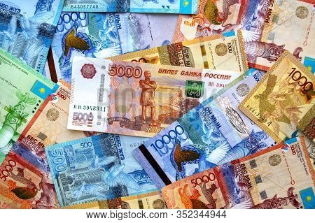 Russian Rubles Banknote On Top Of Kazakhstan National Currency, Top View Of Mixed Tenge Banknotes. K