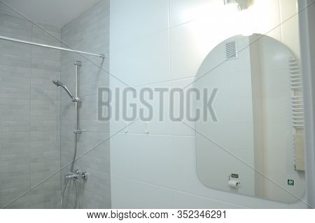 Bathroom With Mirror And Walk-in Shower In New Apartment In Wroclaw, Poland. Studio Type Apartment W