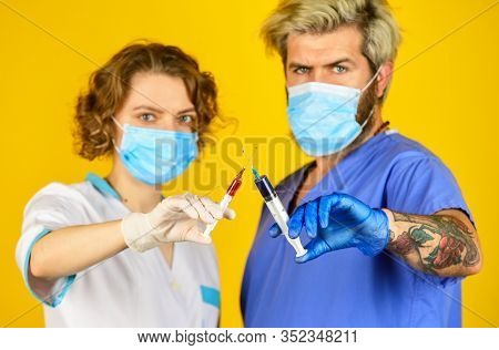 Medical Couple. Virus Remedy Injection. Doctors Wear Respirator Mask. Infection Vaccine And Blood Te