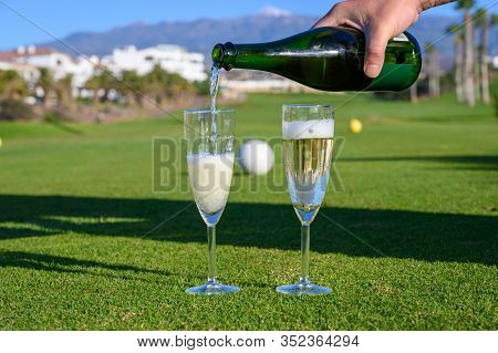 Pouring Of Bubbles White Champagne Or Cava Wine During Golf Competition Event Or Celebration On Gree