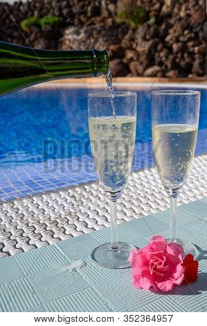 Pool Party With Two Glasses Of Bubbles White Champagne Or Cava Wine, Romantic Event On All Inclusive