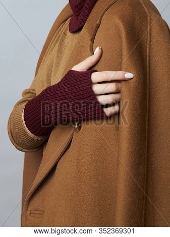 Woman In Coat, Spring Clothes, A Snood Scarf, A Hat And Gloves. The Girl Is Blonde With Blue Eyes. W