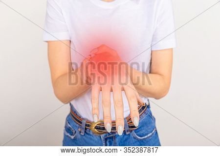 Elderly Woman Suffering From Pain, Weakness And Tingling In Wrist. Causes Of Hurt Include Osteoarthr
