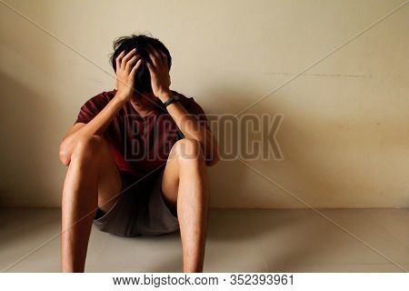 Sad Young Man Sitting Alone In A Empty Room, Sad ,lonely ,chool, Adolescence, Home Violence, Unwante