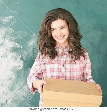 Young Girl With Delivery Box. Happy Female Child Relocation Stuff. Laughing Person Holding Mail Gift