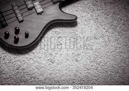 Bass Guitar With Four Strings In Black And White. Detail Of Popular Rock Musical Instrument. Top Vie