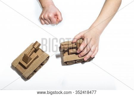 Childrens Hands Play With Tanks. Two Toy Tanks Made By Children From Corrugated Cardboard. Toy Cardb