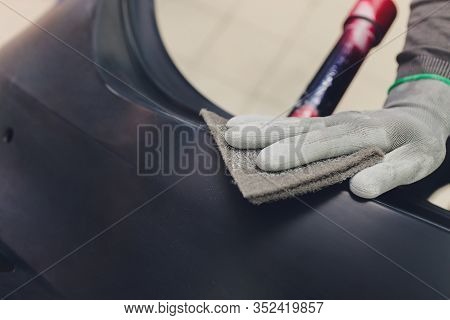 Auto Mechanic Preparing The Car For Paint Job By Applying Polish With The Power Buffer Machine