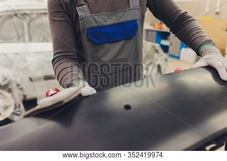 Auto Mechanic Preparing The Car For Paint Job By Applying Polish With The Power Buffer Machine
