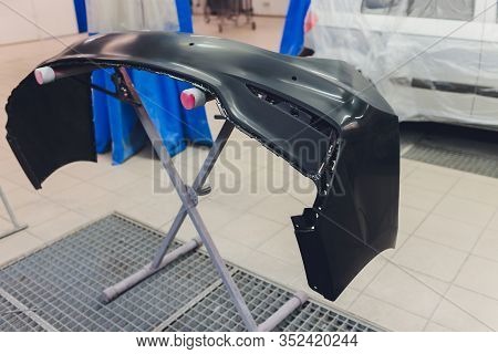 Auto Mechanic Preparing The Car For Paint Job By Applying Polish With The Power Buffer Machine