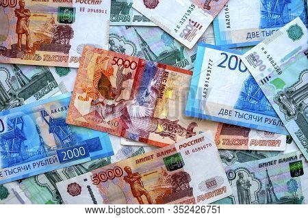 Kazakhstan Money Banknote On Top Of Russian National Currency, Top View Of Mixed Roubles. Tenge And 