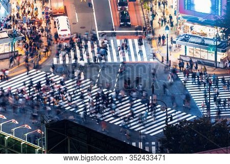 Pedestrians Cross The Shibuya Scramble Crosswalk In Tokyo, Japan, One Of The Busiest Intersections I
