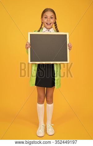 Schoolgirl Wear Raincoat Hold Blank Chalkboard Copy Space. Waterproof Fabric For Comfort. Rainproof 