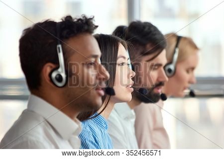 Side View Attractive Japaneese Girl Amoung Colleagues. Focus Of Sitting Asian Girl Between Co-worker