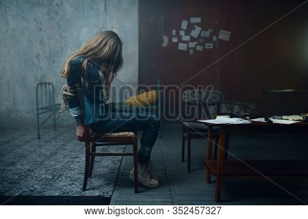 Female victim of maniac kidnapper with taped hands