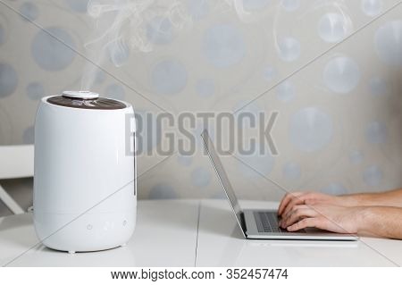 Air Humidifier Stay On The Table And Spreading Steam. Humidification Of The Dry Air. Comfortable Liv