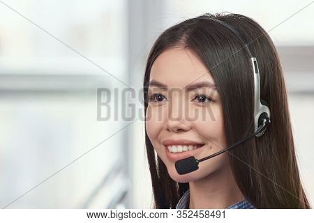 Female Smiling Opearator. Half-turned Young Cheerful Smiling Support Phone Female Operator In Headse