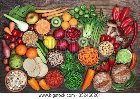 Low glycemic food for diabetics for health & weight loss with foods high in vitamins, minerals, antioxidants, smart carbs, omega 3 & protein. Below 55 on the GI index. Top view on rustic wood.