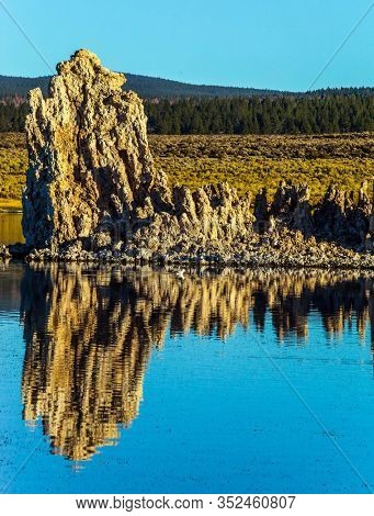 Beautiful reflection. Picturesque Mono lake. Sunset. The columns-remains of bizzare shapes of 