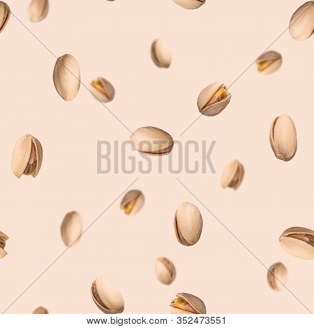 Seamless Pattern With Falling Pistachio Nuts On Beige Background. Levity Kernels.