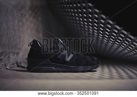 Black New Balance 574 Sneakers Shot Outdoor On Dark Industrial Background. Krasnoyarsk, Russia - Jan