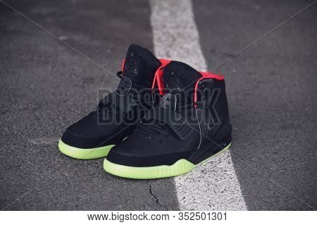 Legendary Nike Air Yeezy 2 Sport Shoes Shot Outdoor On Asphalt Road Line Background. Sport And Casua