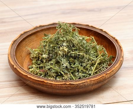 Dried Tribulus Terrestris In The Bowl.  Curative Herb Tribulus Terrestris And  Its Seeds Called Devi