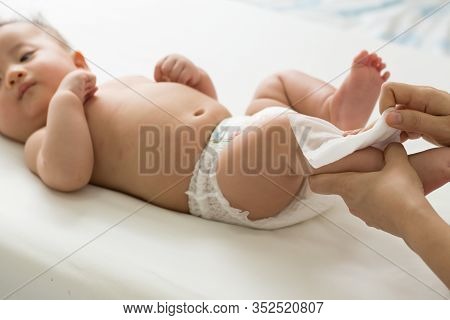 Mom Cleaning Up And Wipe Body Baby By Wet Tissue When Changing Nappies Or Diaper And Wiping The Hand