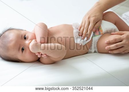 Mom Cleaning Up And Wipe Body Baby By Wet Tissue When Changing Nappies Or Diaper And Wiping The Hand