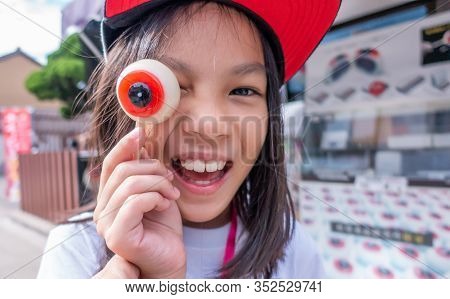 Girl Is Playing With Ghost Eye Moji Candy