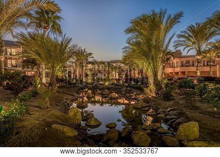 Twilight Reflections In A Stream Of Water In The Garden Of Movenpic Hotel At El Gouna, Egypt, Januar