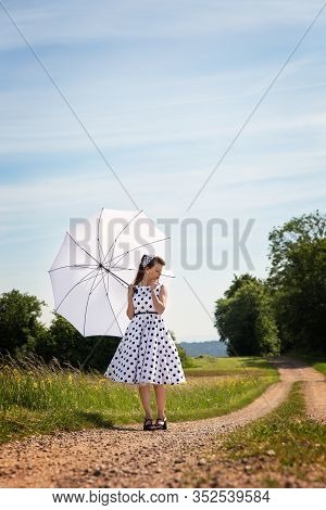 Girl In The Fashion Of The Fifties Und Sixties Posed With A Sunshade In The Nature, Concept Pinup Gi
