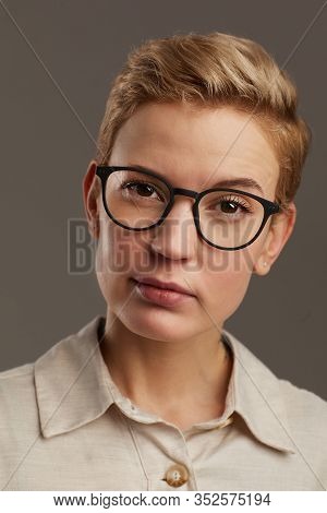 Head And Shoulders Portrait Of Modern Woman Wearing Black Rimmed Glasses With Short Pixie Haircut Lo