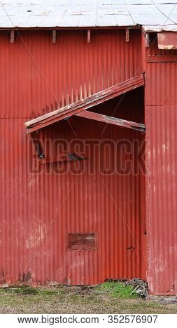 A Red Barn Door And Awning Shed Very Old Abandoned Farm Building