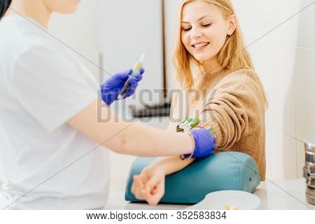 Young Blond Wman In Laboratory In During Blood Research. Unrecognizable Nurse Drawing Blood Sample F