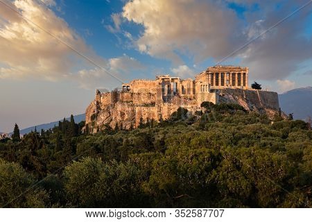 Famous greek tourist landmark - the iconic Parthenon Temple at the Acropolis of Athens as seen from Philopappos Hill on sunset. Athens, Greece