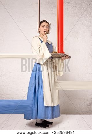 Medieval Young Woman As A Medieval Lady Milkmade On White Studio Background. Trying Fast Food, Fried