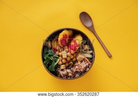 Top View Of Delicious Healthy Vegan Buddha Bowl Meal Filled With Grains, Veggies And Chickpeas.