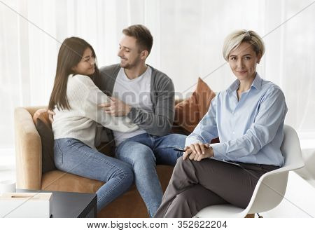Saved Marriage. Professional Family Counselor Smiling Happy About Successful Therapy And Spouses Rec