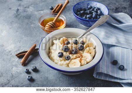 Milk Rice Porridge With Blueberry, Banana, Honey And Cinnamon, Creamy Rice Pudding Or French Riz Au 