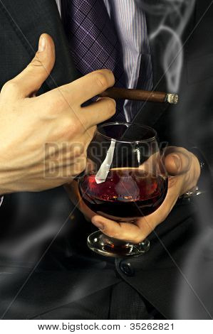 Old Brandy Glass At Male Hand, Smoking Cigar