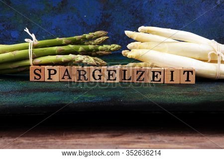 White And Green Asparagus On Background With Spargelzeit Wooden Letter.