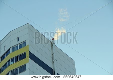 Boiler Room Smoking Pipe Attached To The Wall Of A Panel Modern House Against A Clear Blue Sky. Stoc