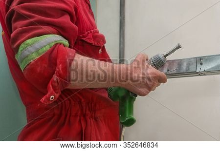 A Worker Mounts A System For Drywall